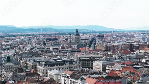 Aerial panoramic view of historic urban borough with landmarks and tourist sights. Two slim towers and one dome of St. Stephens Basilica. Budapest, Hungary photo