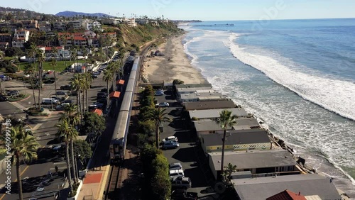 4K drone aerial tracking and stablishing shot of a beach with a pier in California photo