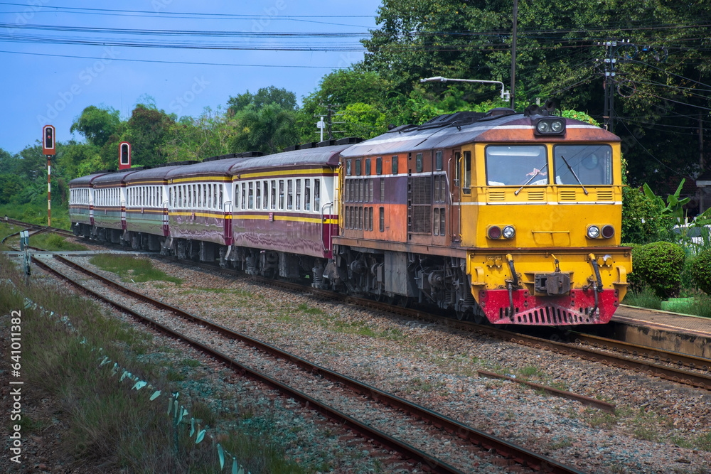 Passenger train by diesel locomotive on the railway.