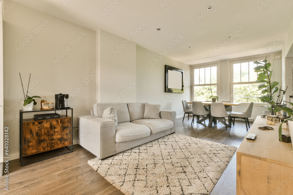 Fototapeta premium a living room with white walls and hardwood flooring in the center of the room, there is an area for furniture to sit