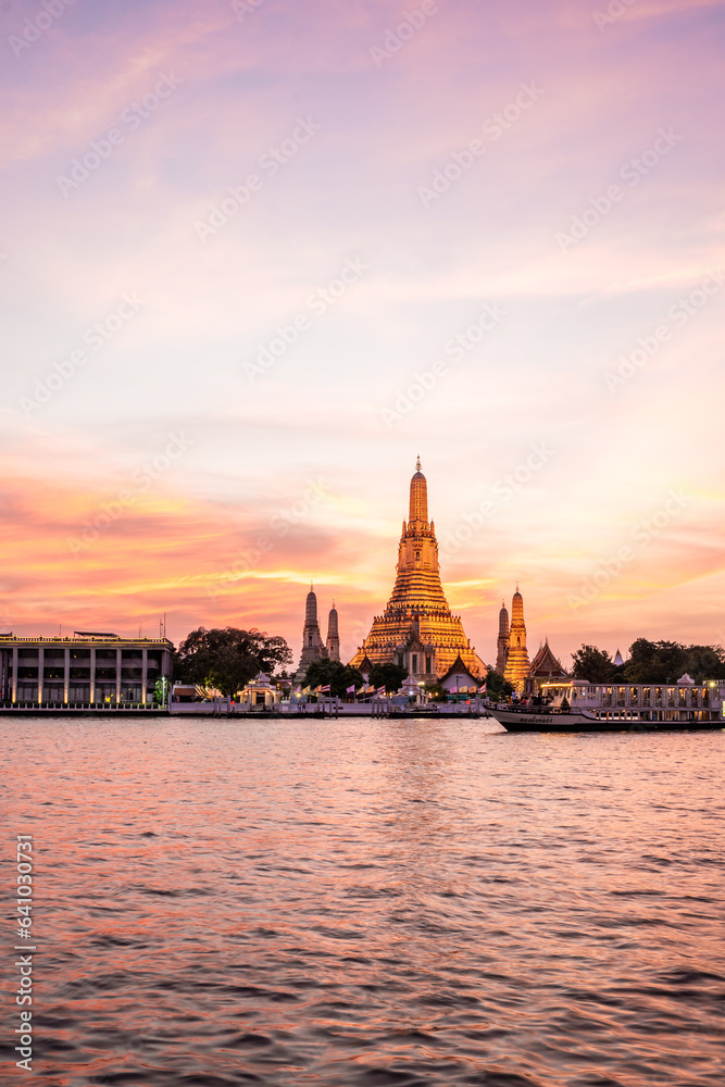 Wat Arun Temple during Sunset at Chao Praya River Bangkok, Thailand.