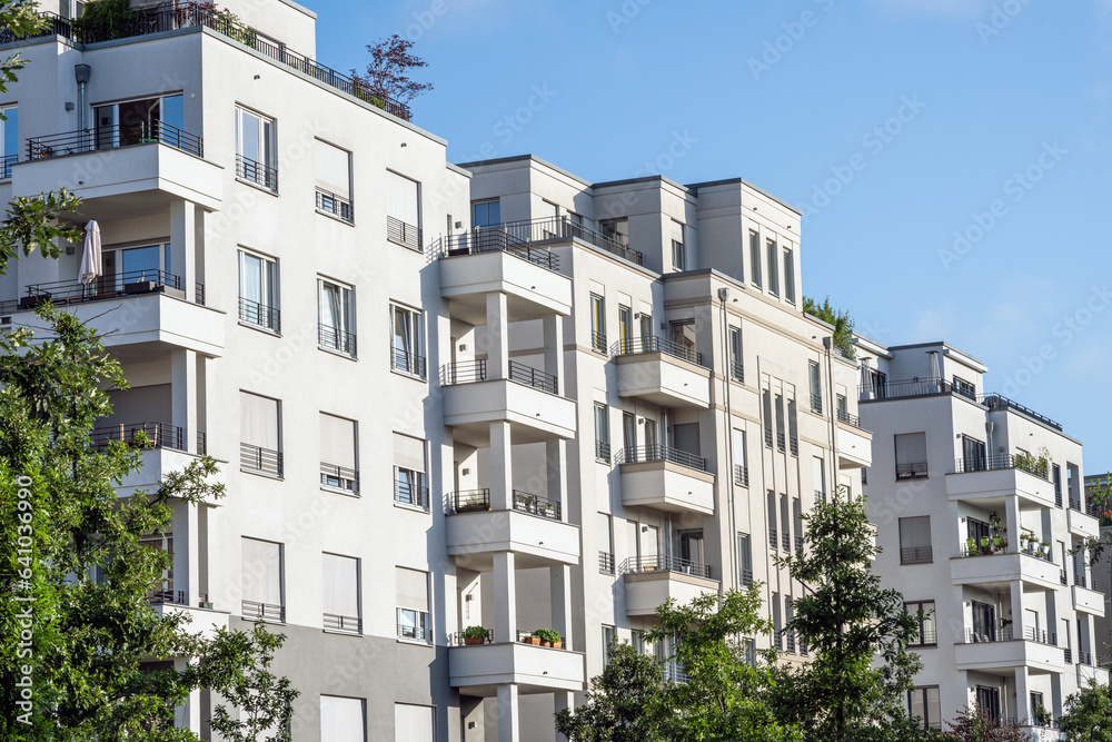White apartment building with trees seen in Berlin, Germany White apartment building with trees seen in Berlin, Germany