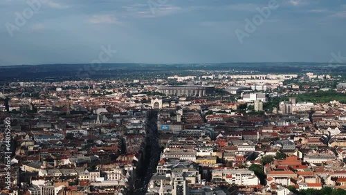 Aerial panoramic view of urban borough in metropolis at golden hour. Modern sports stadium, Puskas Arena in background. Budapest, Hungary