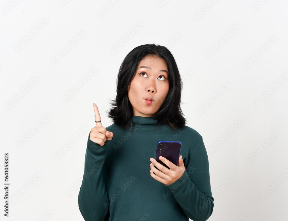 Holding Smartphone Pointing up Of Beautiful Asian Woman Isolated On White Background
