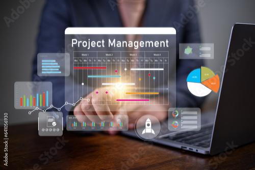 Project management concept, businessman working with schedule plan to manage work projects and update tasks. Work progress, project plan, efficient scheduling.