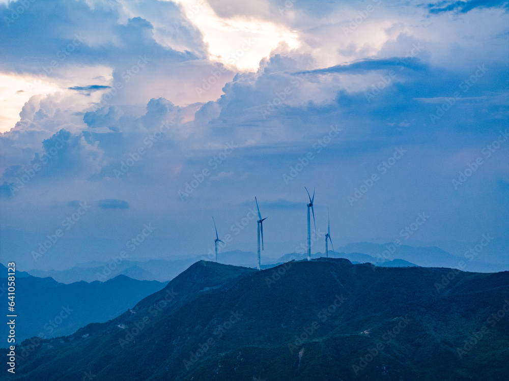 Obraz premium Wind power on the mountain, blue sky and white clouds