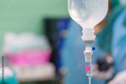 Normal saline solution or sodium chloride with infusion bottle drip for patient in hospital, Intravenous system of operating surgeons