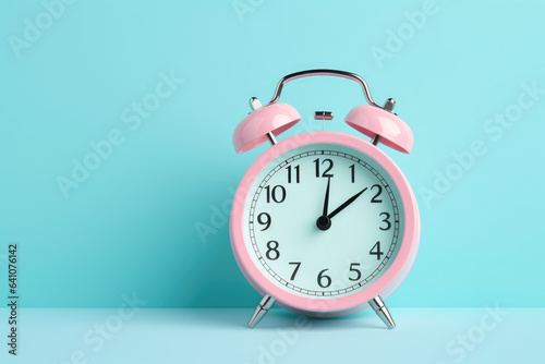 Retro alarm clock on mint green background. Back to school concept. Copy scpace
