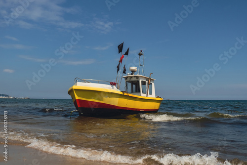 Fishing boat on the beach in Sopot, Poland. Magnificent long exposure calm Baltic Sea. Wallpaper defocused waves. Fishermans sea bay Vacation and holidays. travel attraction tourist destination 