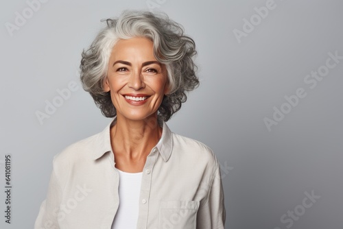 Beautiful gorgeous 50s mid age beautiful elderly senior model woman with grey hair laughing and smiling. Mature old lady close up portrait. Healthy face skin care beauty  skincare cosmetics  dental.