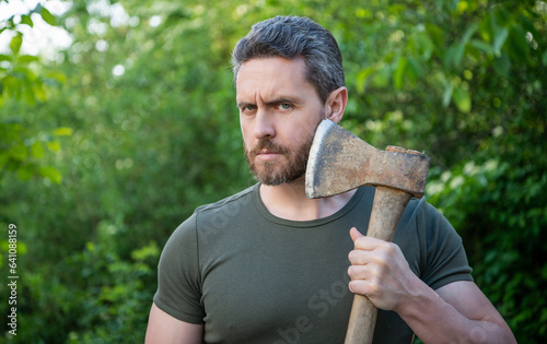 masculine guy with axe outdoor. photo of masculine guy with axe outside. masculine guy with axe