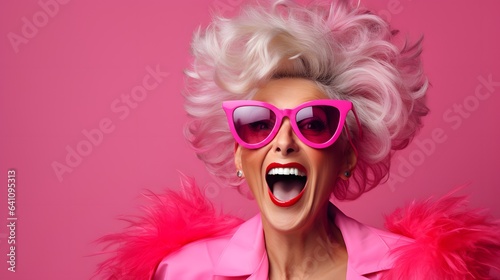 A stylish woman in a pink ensemble with trendy sunglasses