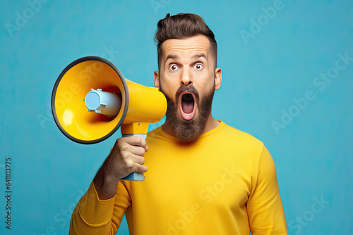 Surprised face of young bearded man wears blue shirt hold scream in megaphone announces discounts sale Hurry up isolated on plain yellow background. Generative Ai