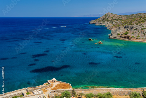 The ruins of an ancient Venetian fortress overlooking crystal clear, shallow ocean waters