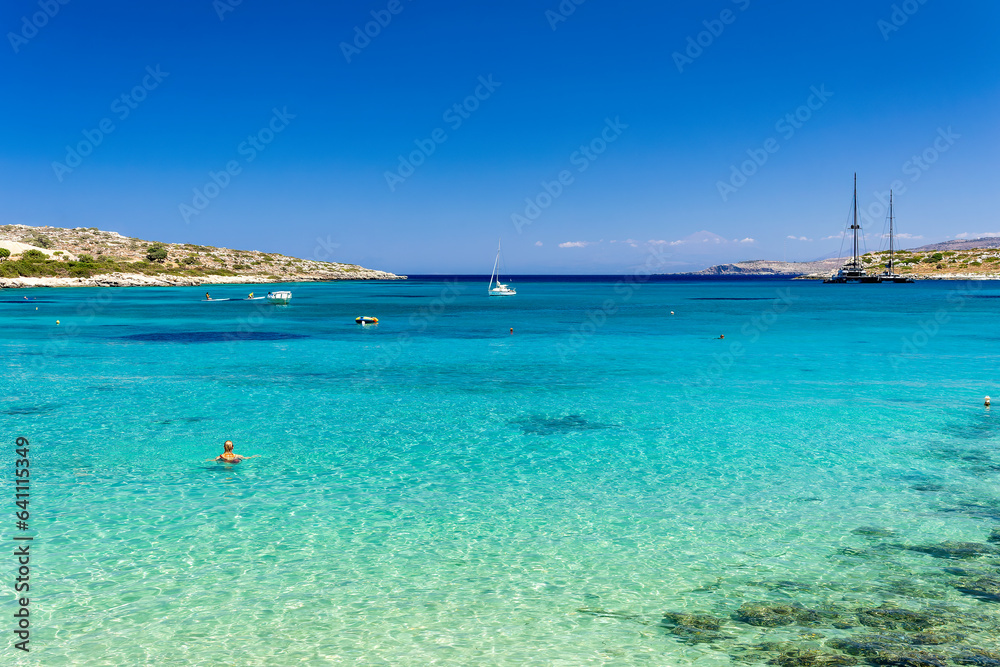 Swimmers in shallow, warm crystal clear ocean waters (Greece)