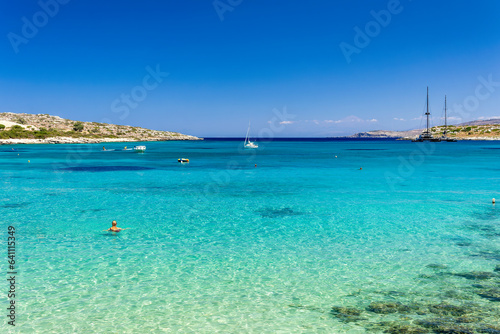 Swimmers in shallow, warm crystal clear ocean waters (Greece)