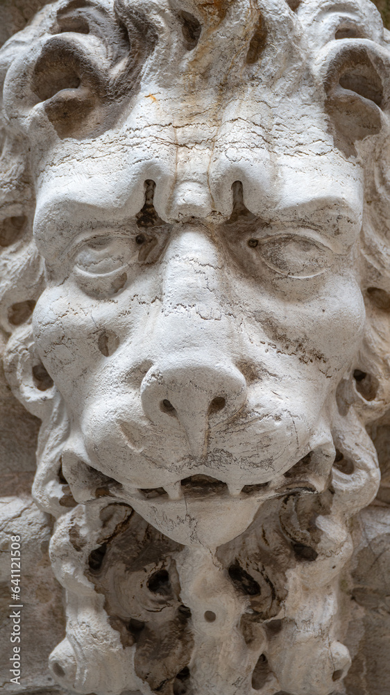 Venice, Italy - Ancient building decoration element of a scary lion head in Venice historical and touristic downtown, details. Concept of conservation of historical heritage Venice, Italy - Ancient building decoration element of a scary lion head in Venice historical and touristic downtown, details. Concept of conservation of historical heritage
