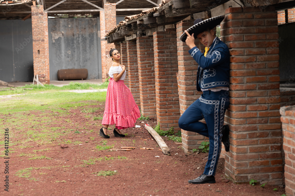 Obraz premium Latin couple of dancers wearing traditional Mexican dress from Guadalajara Jalisco Mexico Latin America, young hispanic woman and man in independence day or cinco de mayo parade or cultural Festival
