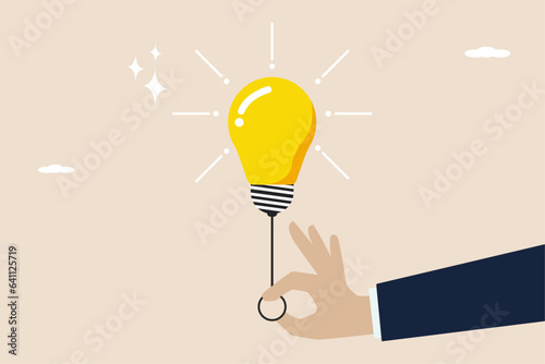 Business ideas and solutions to solve problems, find new idea concepts, smart businessmen turn on the light switch to light up an idea.