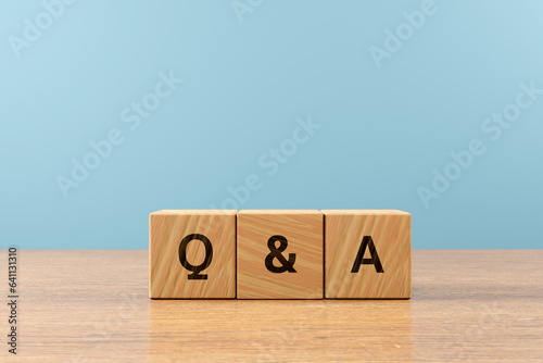 Wooden cube block word Q & A on wood table, 3D render