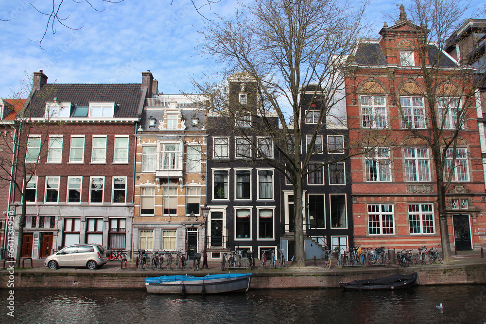 canal and old brick houses in amsterdam (netherlands)