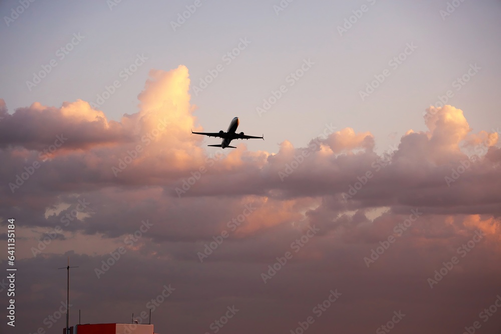 Airliner Taking Off with Dramatic Clouds