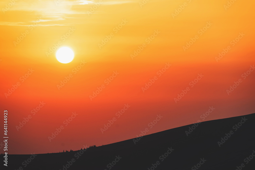 Beautiful sunset in a mountainous area. The sun sets on the mountain. Beautiful sunset in a mountainous area. The sun sets on the mountain.