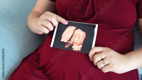 Pregnant woman holding baby Photos