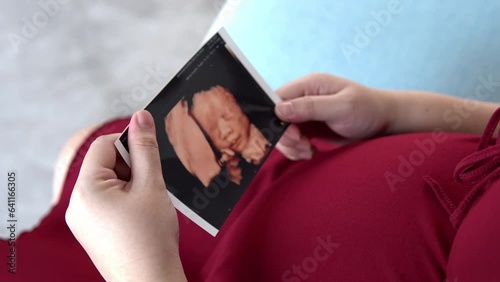 Pregnant woman holding baby Photos