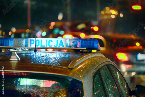 W nocy radiowóz policji polskiej w czasie deszczu na patrolu. photo