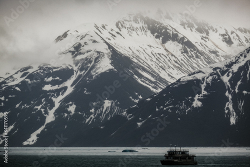 Cruise to Hubbard Glacier Bay in Alaska with floating ice bergs and drift ice floes on ocean water surface surrounded by snow cap mountains and wildlife wild nature scenery Last Frontier adventure