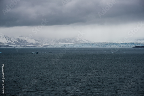 Cruise to Hubbard Glacier Bay in Alaska with floating ice bergs and drift ice floes on ocean water surface surrounded by snow cap mountains and wildlife wild nature scenery Last Frontier adventure photo