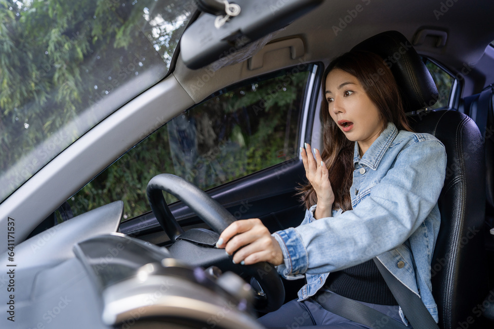 Asian woman shocked and shouting while driving on the road She was involved in a car accident. Asian woman shocked and shouting while driving on the road She was involved in a car accident.