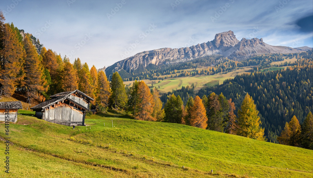 Alpine meadows with barns in Autumn, Dolomites, Italy