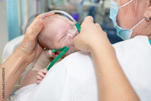 Baby with an oxygen mask in the neonatal unit.Baby wear oxygen mask