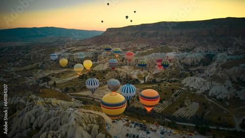 Lots of hot air balloons above fairy chimneys rock formations. Aerial view of Cappadocia. Goreme, Nevsehir province, Turkey