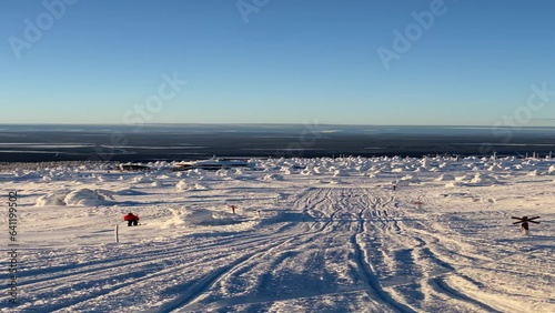arctic winter in Finland, on a snow slope with frozen trees
