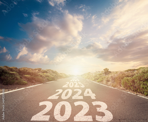 New year 2024. Text year 2023, 2024, 2025 written on the road. Concept of planning, goal, challenge, new year resolution.