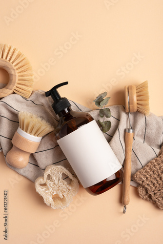 Dispenser bottle, loofah sponge, jute washclothes and eco dish brushes. photo