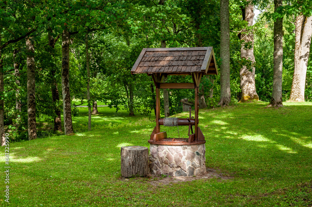 Old well water pump in garden. Stende Manor, Latvia. Old well water pump in garden. Stende Manor, Latvia.