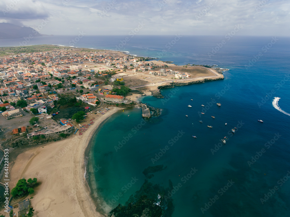 Aerial drone Tarrafal in Santiago Island, Cabo Verde showcase golden beaches, azure waters, and rugged mountains, it's a paradise for nature lovers. The charming town, historic sites