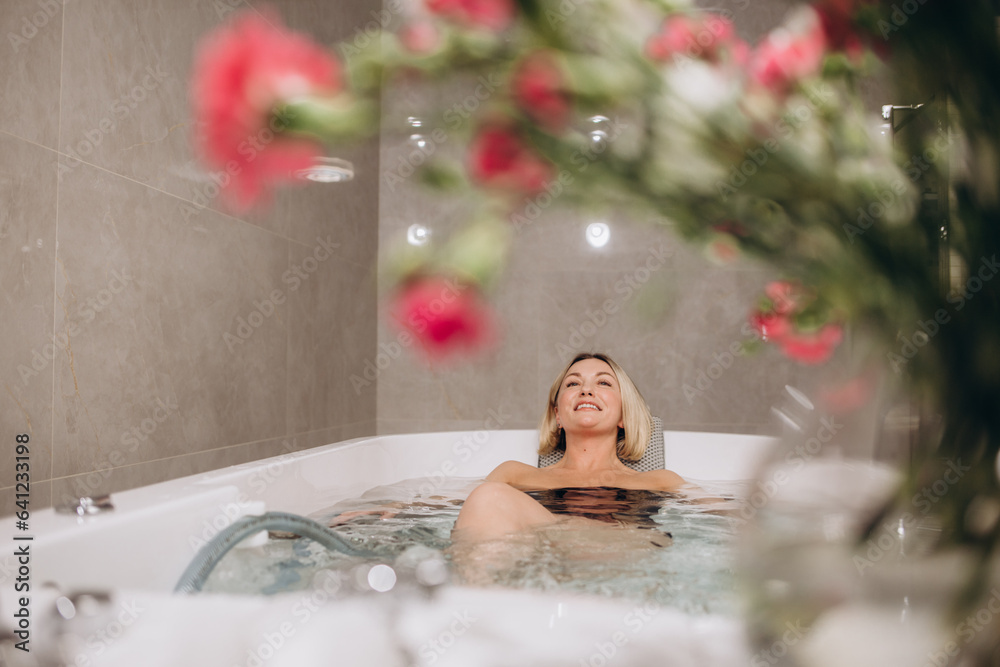 Young beautiful woman enjoying in hydromassage during spa treatment. Young beautiful woman enjoying in hydromassage during spa treatment.