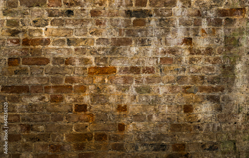 Texture of an old brick wall in a warm and very textured tone.