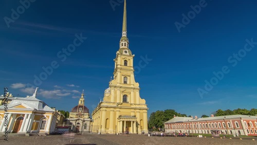 Citadel's Charm: Peter and Paul Fortress Timelapse Hyperlapse. Petropavlovskaya Krepost, Iconic Landmark in St. Petersburg, Russia. Front View of Facade Against a Blue Cloudy Sky photo