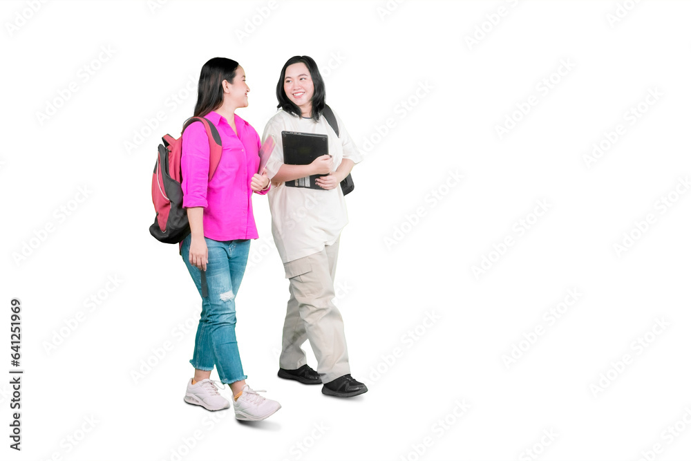 College friends walking and talking, having break after classes College friends walking and talking, having break after classes