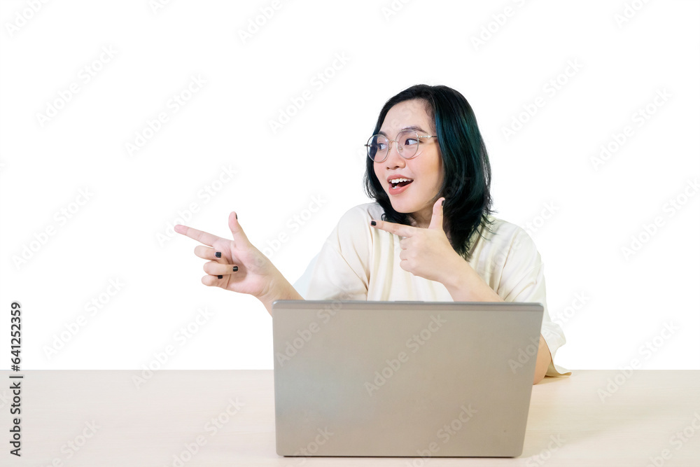 Asian female working on laptop with finger point empty space Asian female working on laptop with finger point empty space