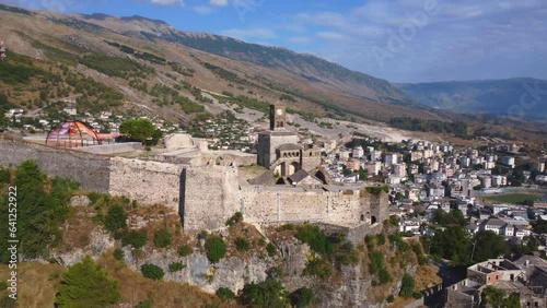 Aerial drone view of the old castle and fortress of the city of Gjirokaster or gjirokastra, Albania. Lateral horizontal panoe next to the Kulla e Sahatit church photo