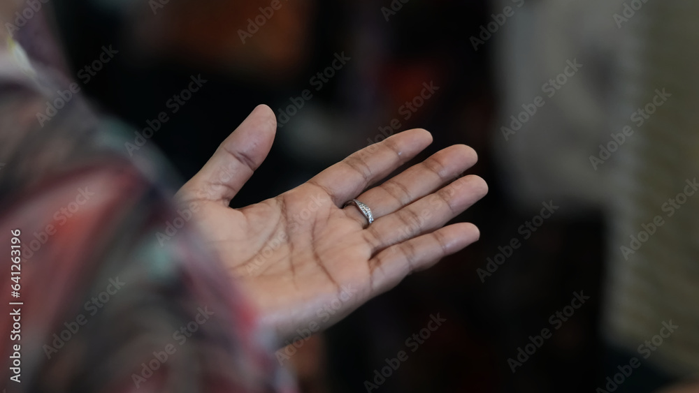 Human hand praying, raising at Church.