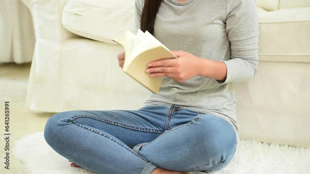 Relax asian woman reading book sitting on sofa in living room holding book to read. Young woman relaxation reader reading open book leisure mind. Happiness beauty woman person smiling face happy time Relax asian woman reading book sitting on sofa in living room holding book to read. Young woman relaxation reader reading open book leisure mind. Happiness beauty woman person smiling face happy time
