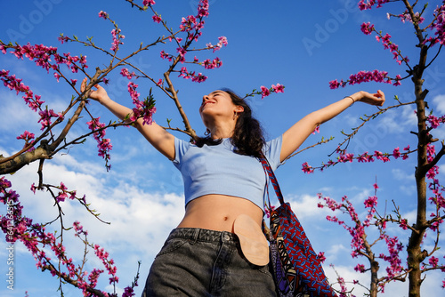 Woman celebrate recovery from colon cancer smiling at the sky in a field of flowers. Female colon cancer survivor